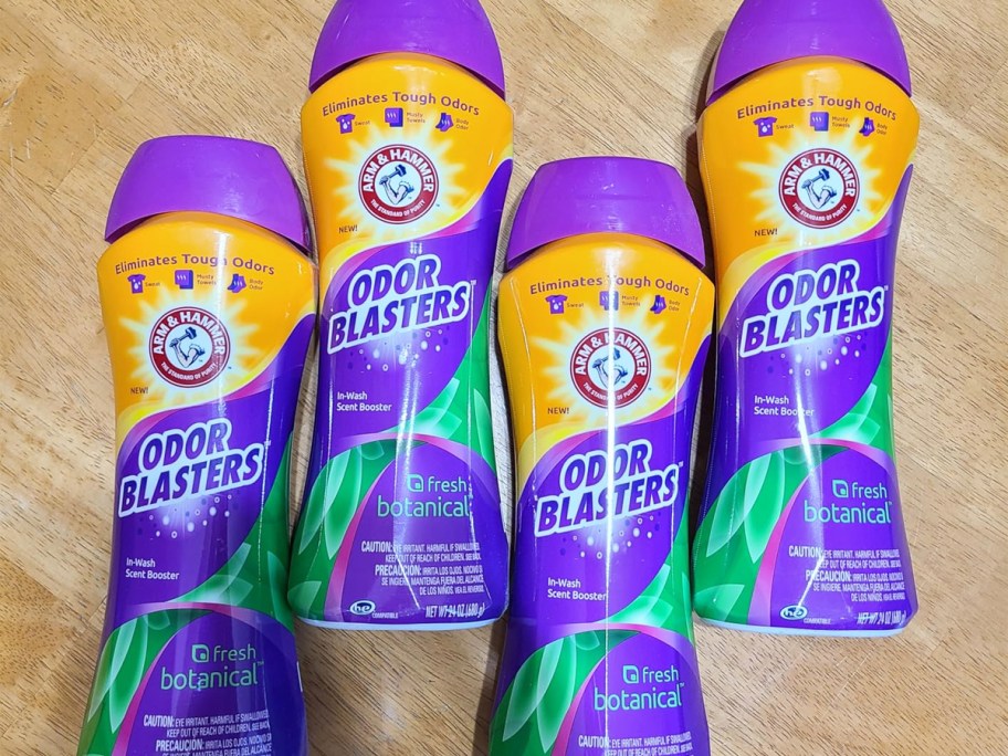 4 purple bottles of Arm & Hammer Scent Boosters on floor
