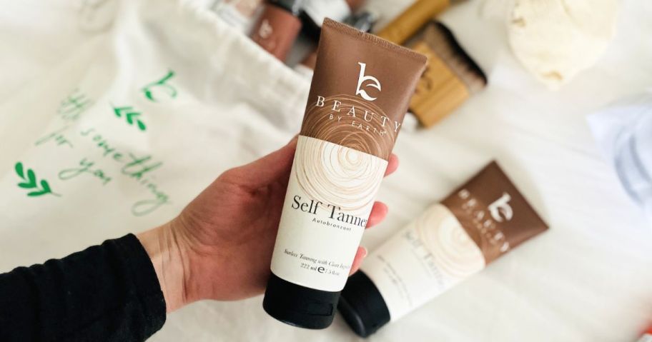 Beauty By Earth Self Tanner in hand