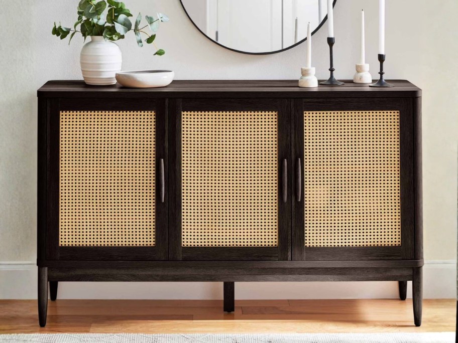 better homes & Gardens caning sideboard cabinet with decorations on top