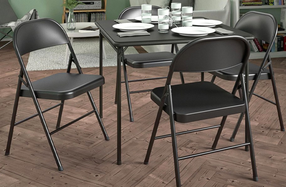 black metal folding chairs around a card table