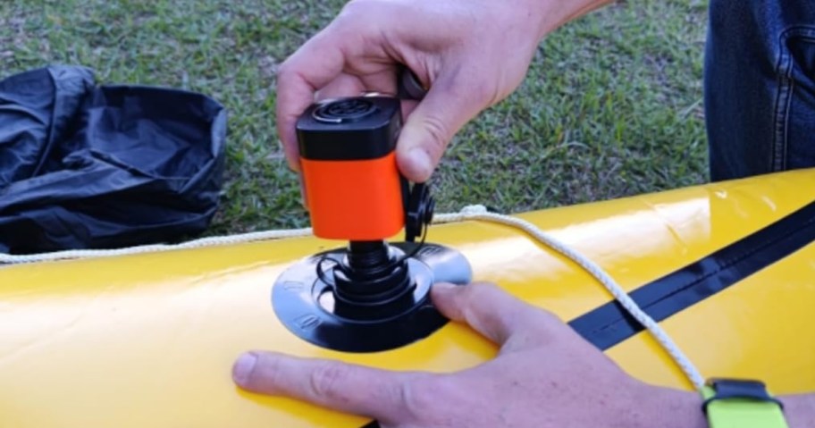 small air pump blowing up an inflatable kayak