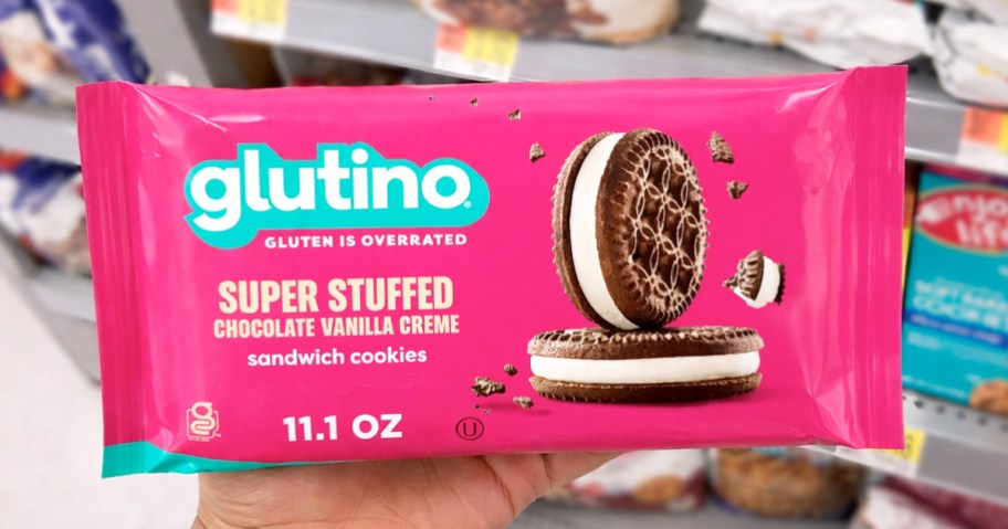 hand holding a pink package of Glutino Cookies