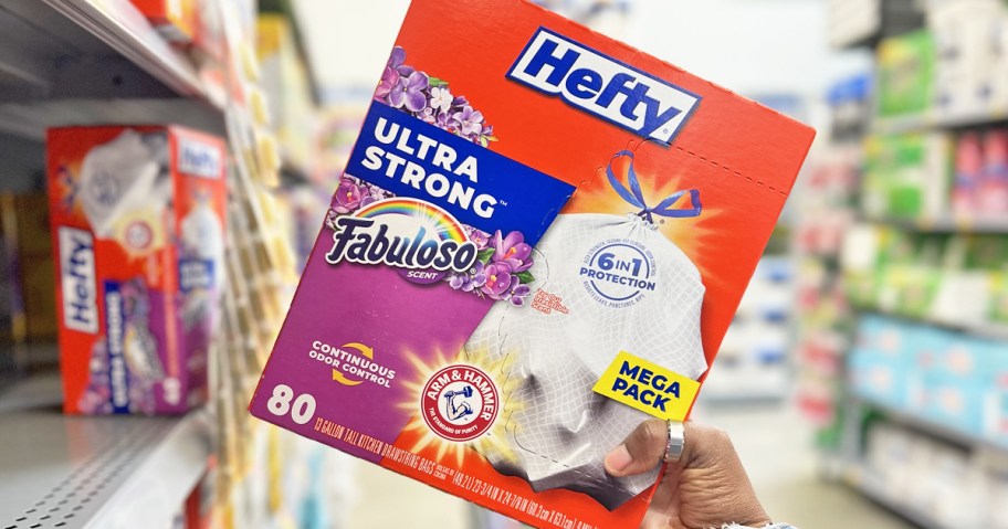 hand grabbing a box of trash bags from store shelf