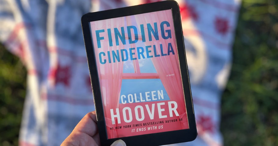 hand holding kindle with Finding Cinderella book on screen