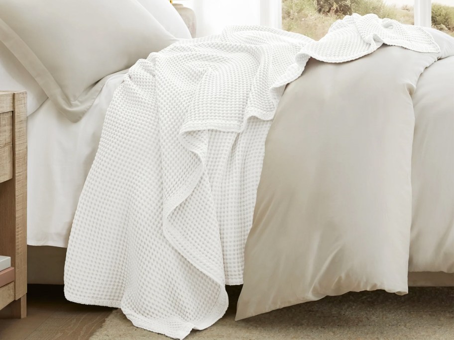 white waffle blanket draped on a bed