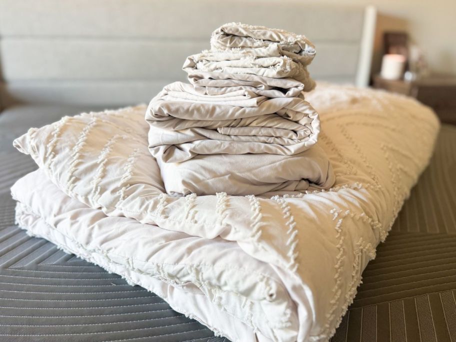 A stack of folded Litanika sheets and a comforter