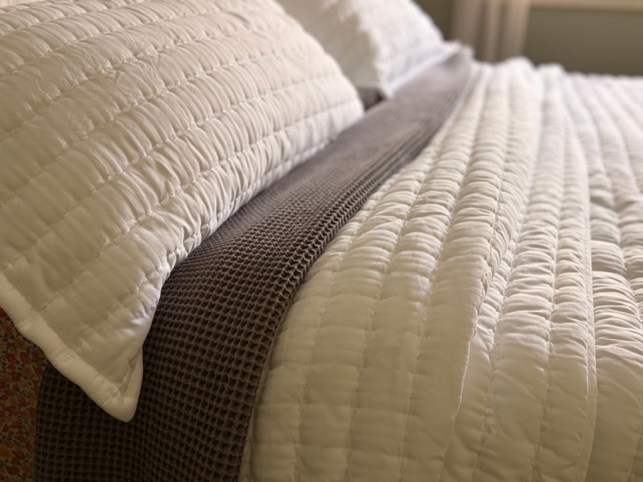 white quilted bedspread on bed