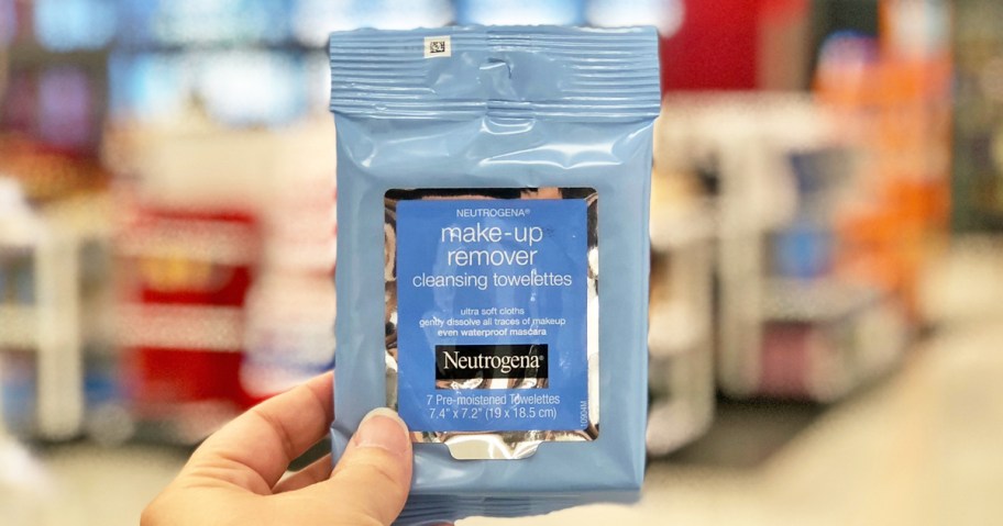 hand holding a travel size pack of Neutrogena Makeup Wipes in store