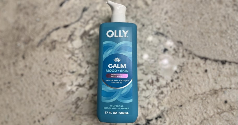 bottle of olly body wash in calm scent on granite countertop