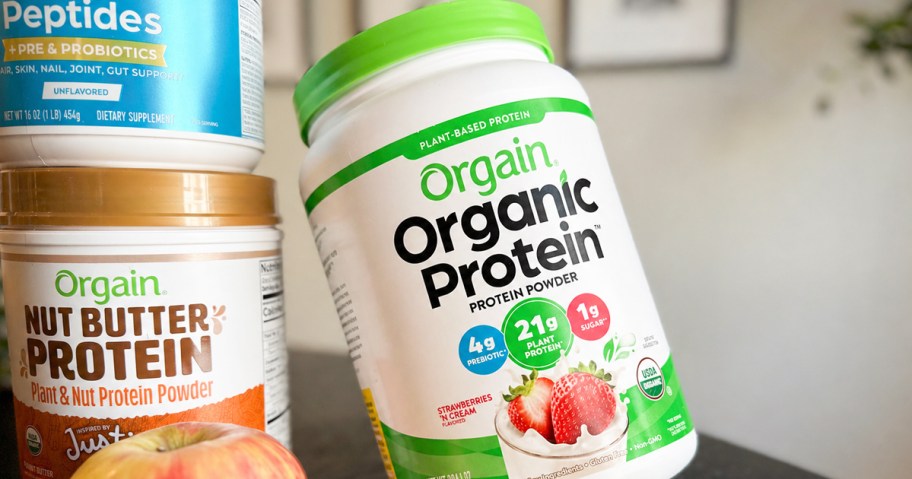 jar of Orgain Protein Powder on table with other jars