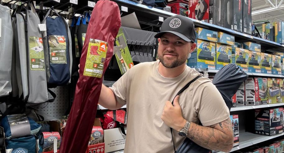 man holding ozark chairs at the walmart store