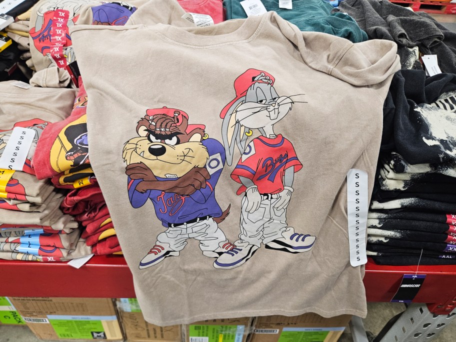 Looney Tunes graphic tees on top of other tees in store