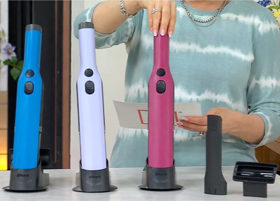 Blue, lavendar and pink Shark WandVacs being presented on QVC