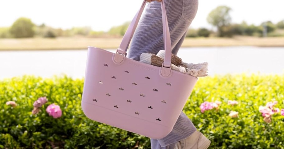 woman carrying simple modern disney tote bag in purple with crowns