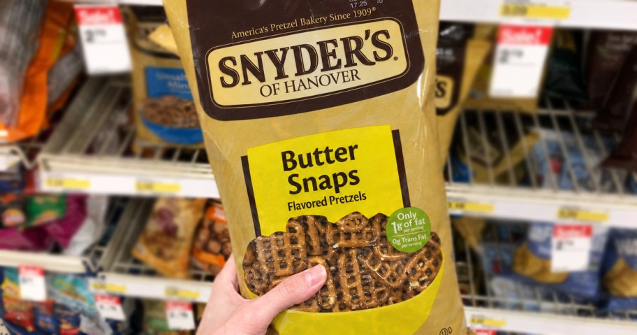 hand holding a bag of Snyder's Butter Snaps Pretzels in store
