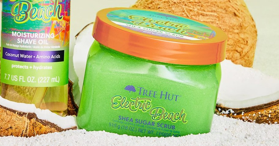 green jar of Tree Hut Electric Beach Shea Sugar Scrub in sand