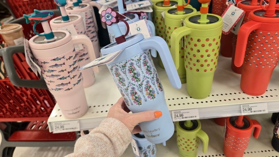 womans hand holding a printed tumbler