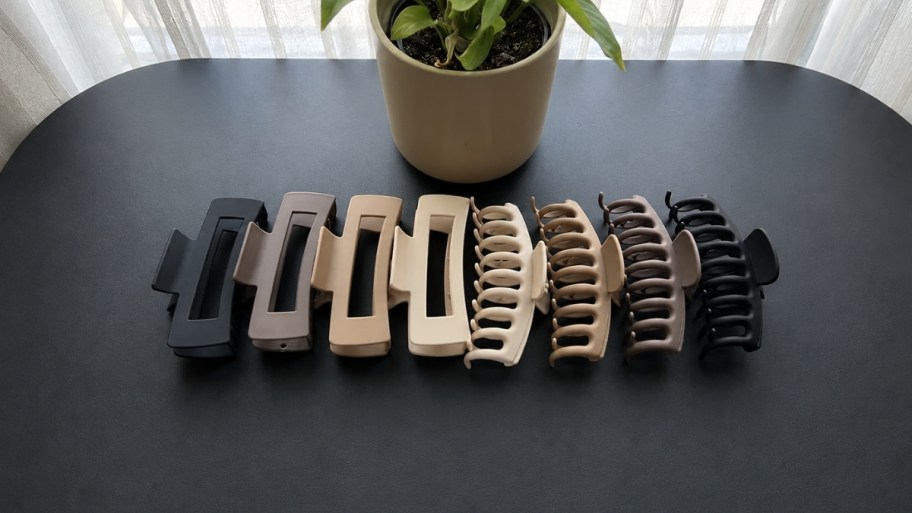 8 claw clips in assorted colors on a table top