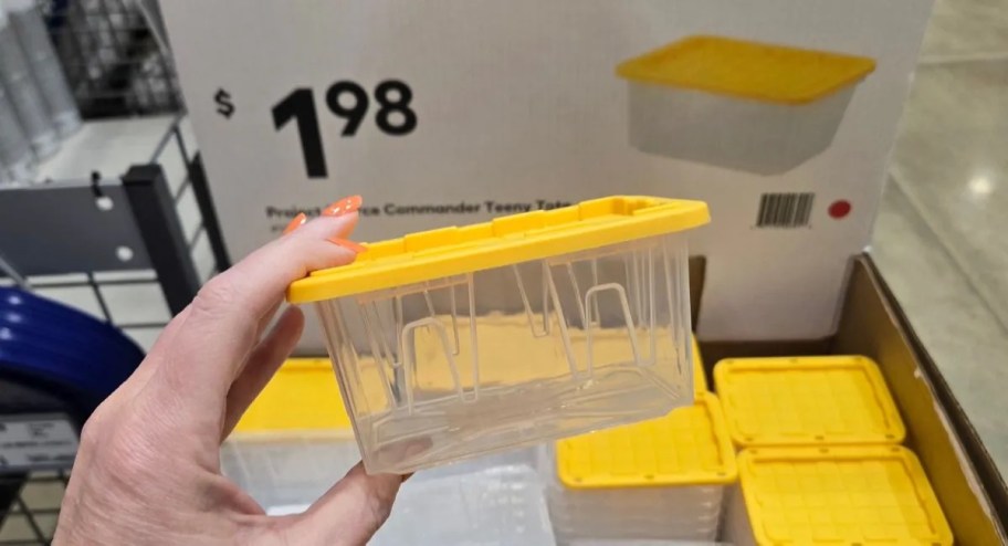 hand holding clear yellow mini tote 