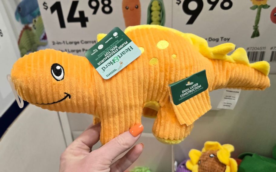 hand holding dino toy 