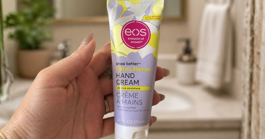 hand holding a tube of eos Hand Cream