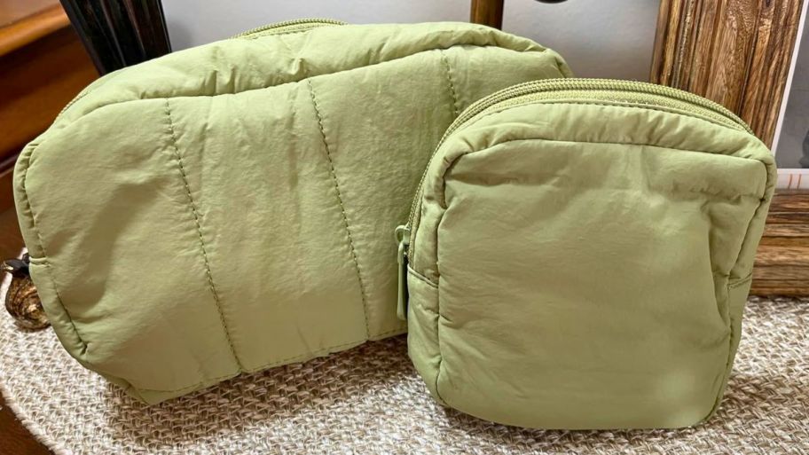 two green makeup bags