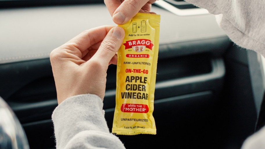  hands opening an ACV pouch 