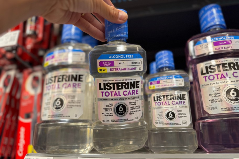 hand grabbing clear mouth wash off shelf