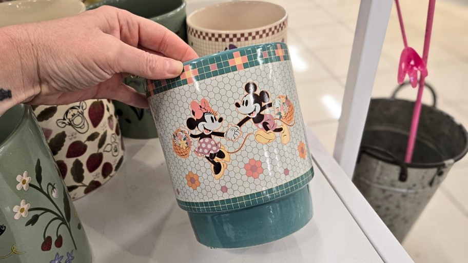 a minnie and mickey mouse ceramic planter