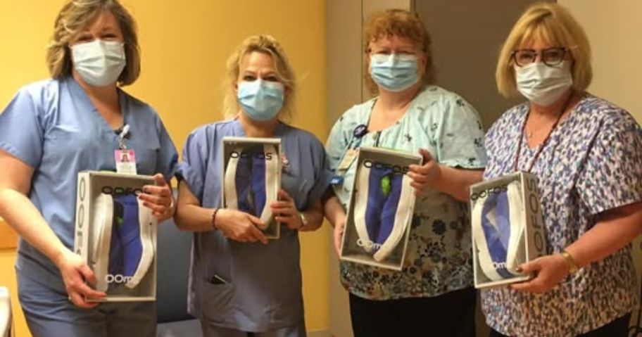 nurses holding boxes of OOFOS shoes