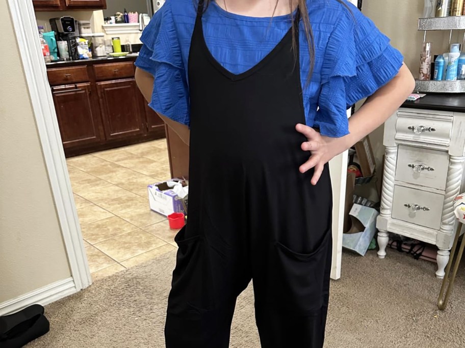 girl in a black romper with a blue shirt