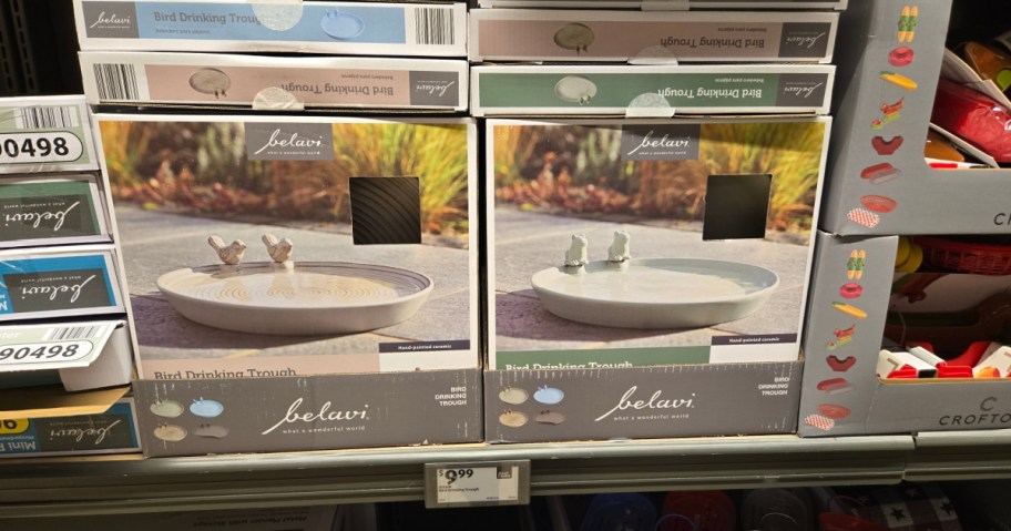 Boxes of Belavi Bird Drinking Troughs on a store shelf, featuring images of ceramic bowls with small bird sculptures.