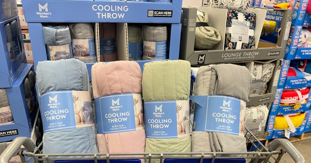 Four different colored cooling throws inside Sam's Club shopping cart