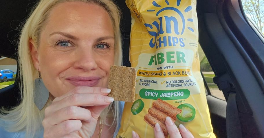 woman holding a bag of Sun chips Fiber Chips