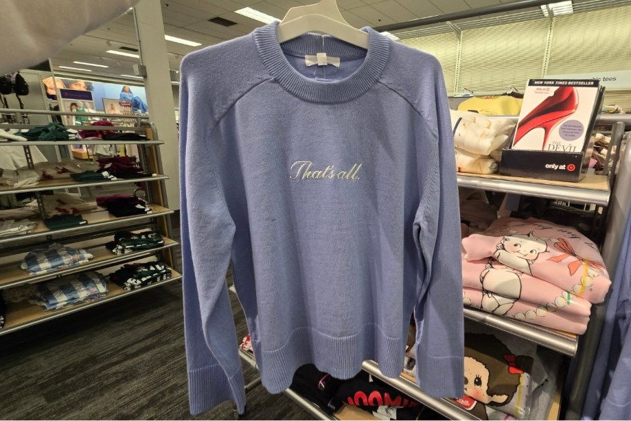 graphic sweater on a hanger