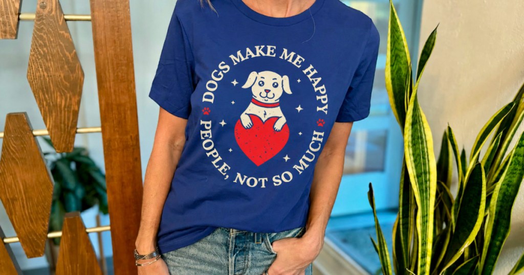 Woman wearing blue T-shirt that says dogs make me happy