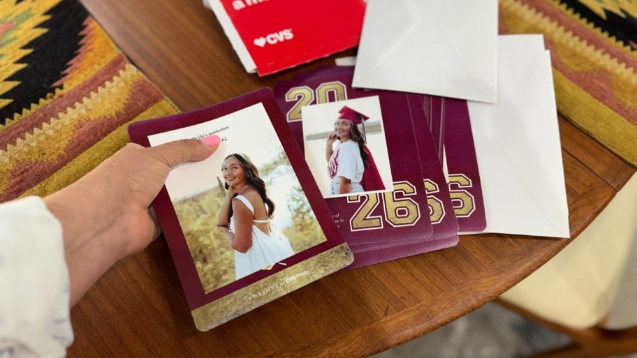a woman holding a graduation announcement premium photo card