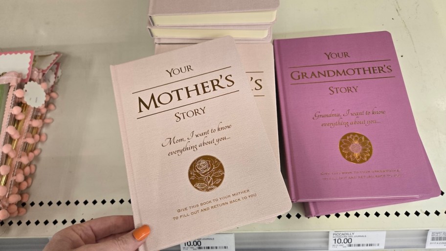 hand holding your mother's story book on store shelf